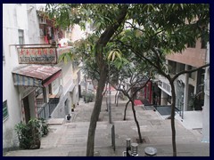 A hilly street with stairs leading from SoHo to Central.