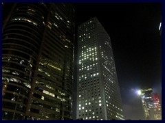 Central by night - Four Seasons Place and Jardine House with its round windows.