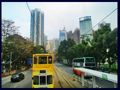 Double decked buses and trams in Causeway Bay.