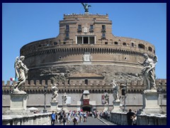 Castel Sant'Angelo (Castle of the Holy Angel) is a huge ancient fortress in cylindrical shape on the West banks of the Tiber, near the Vatican. 
It is connected to the old city center by Ponte Sant'Angelo, a bridge with beautiful religious sculptures. It was built 123-130, commissioned by Emperor Hadriani as a mausoleum for himself and his family, for long the tallest building in Rome. It has been used by popes as a fortress, residence and castle, as a prison, a military fortress (in 401), and is today a museum that is one of the most popular attractions in Rome. There is an outer wall around the actual building. creatomg a courtyard, and there are sloping passages that leads down to the ground floor. Inside the fortress you will find a lot of canons, several outdoor viewing decks, surrounding terraces, an art museum, a café and a library. There is an elevated passage called Passetto di Borgo, that connects Castel Sant'Angelo with the Vatican City, so that the pope can escape if we the Vatican is attacked. It had a special role in Dan Brown's Angels and Demons.
