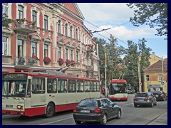 Old and newer trolley buses in front of a pink house, Naujamiestis (New Town).